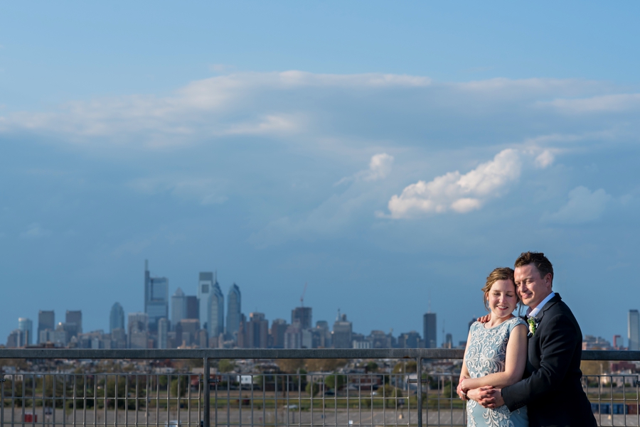 A bride and groom in front of the Philadelphia Skyline.